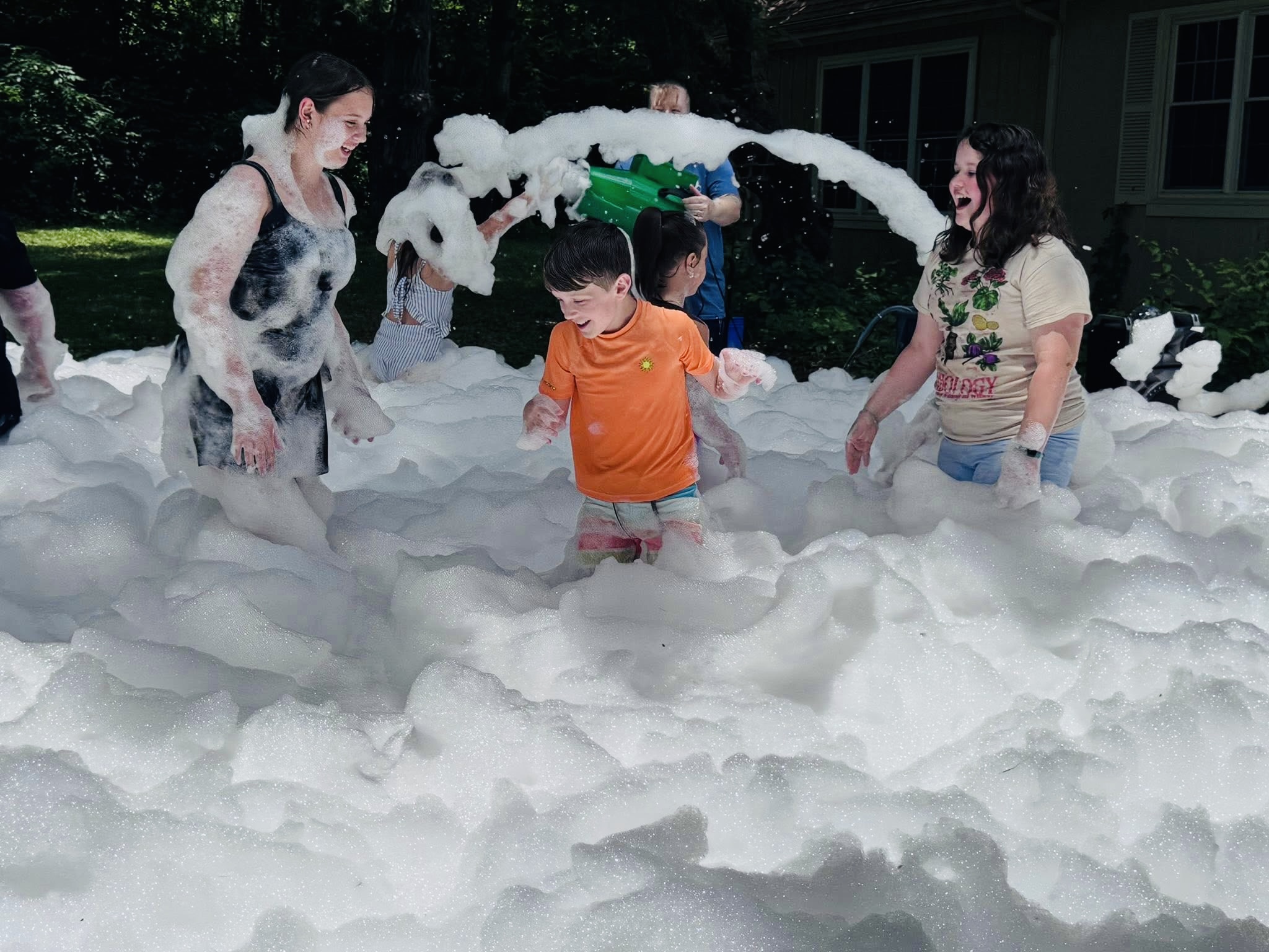 Kids splashing and throwing foam in the yard