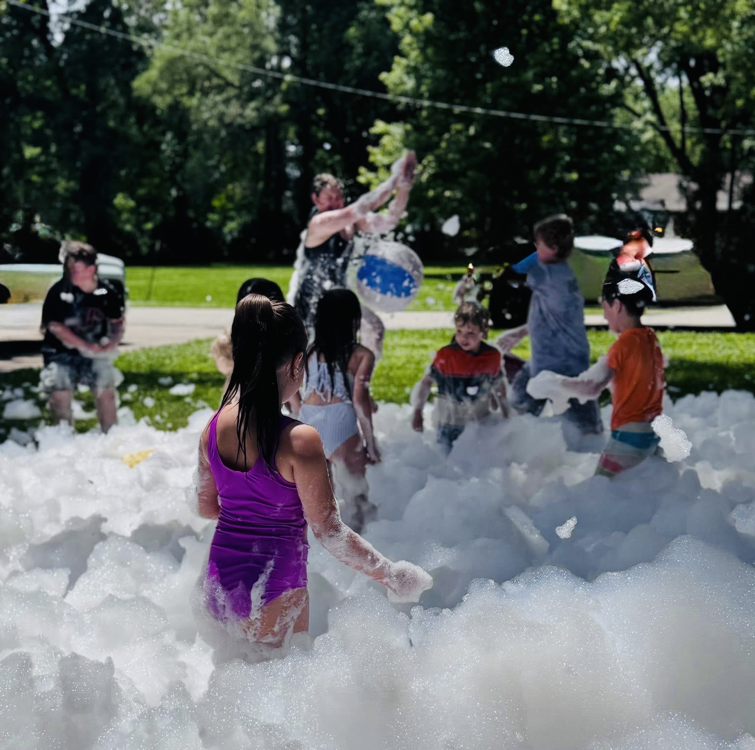 Wide view of a packed foam party with the cannon spraying
