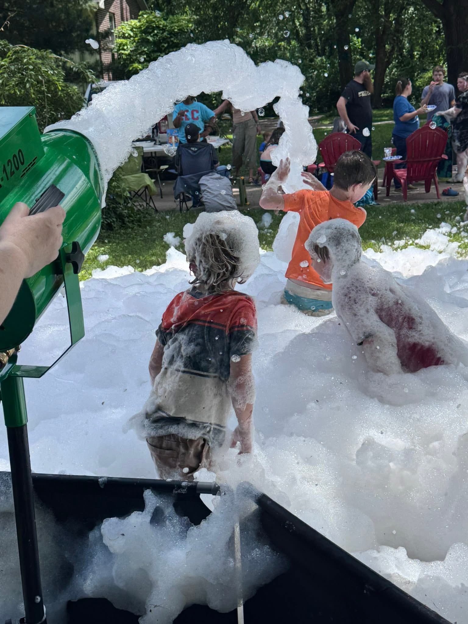 The foam cannon machine blasting foam onto kids
